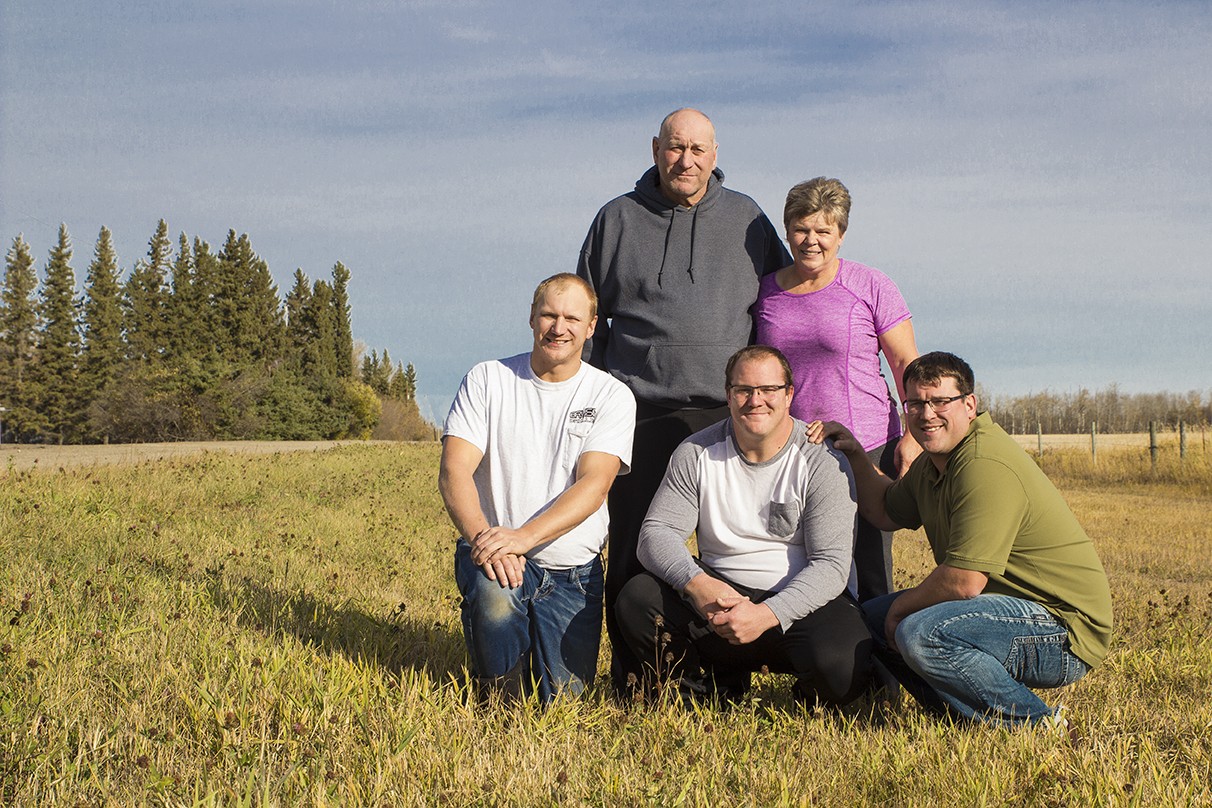 Bryson Drilling founders Brian and Cindy Sunderland posing outside with their three diamond drilling sons