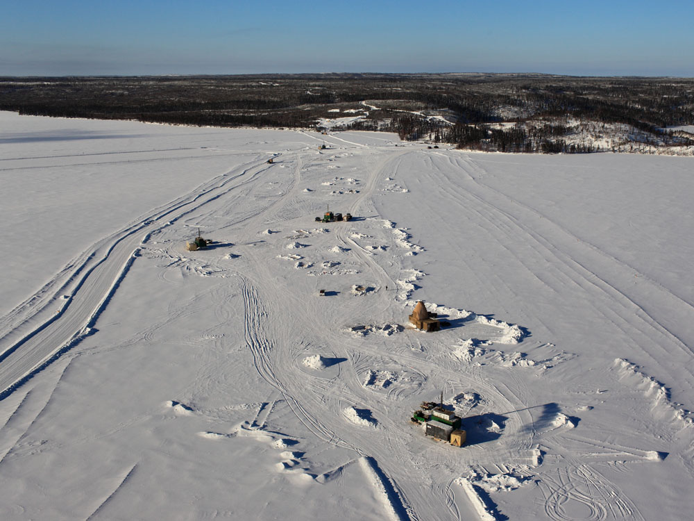 aerial view winter ice roads made by Bryson Drilling with diamond drilling equipment setup on a northern Canadian diamond drilling frozen lake site